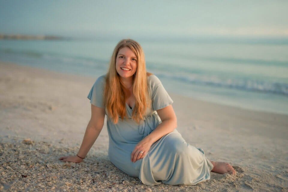 Happy expectant mother on the beach - a photo by Katrina Photography