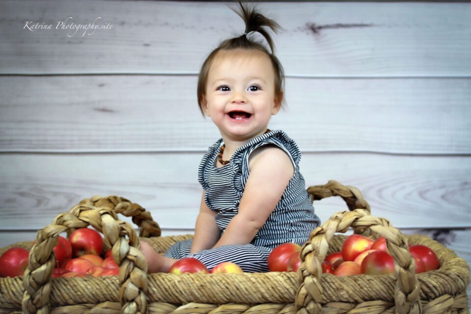 Baby Girl Is In The Basket With Apples - photo by Katrina Photography